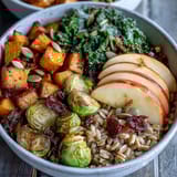 Sautéed kale and cinnamon apples mingle in a Fall Vegetable Bowl, served over hearty farro grains.