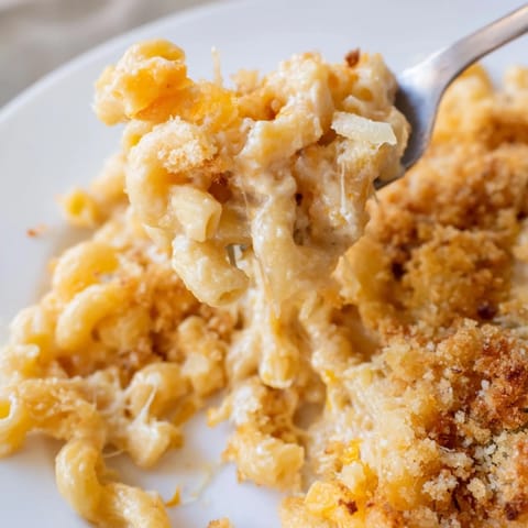 Freshly baked Macaroni and Cheese featuring tender elbow pasta coated in a rich, creamy cheddar cheese sauce.
