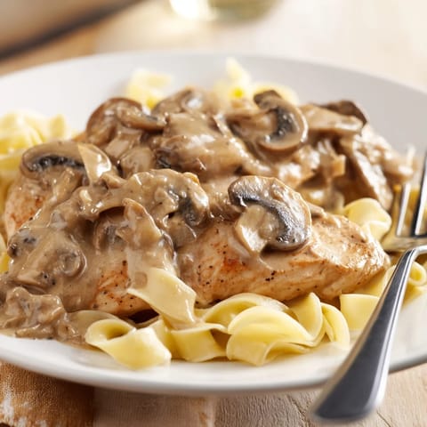 Tender pan-seared chicken in a rich, garlicky Marsala cream sauce, paired with al dente fettuccine for a comforting Italian-American meal.  