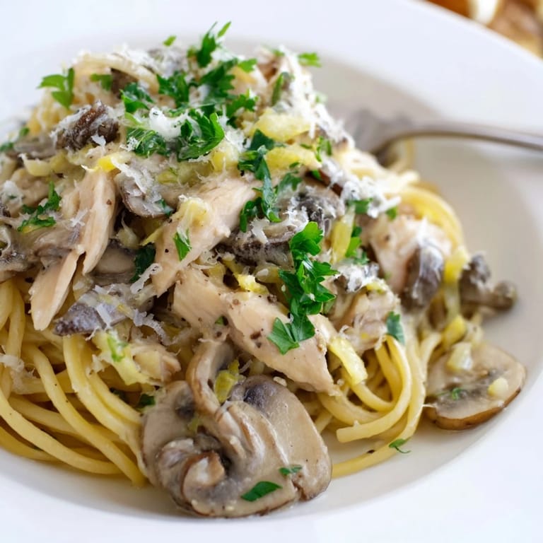 Sliced chicken and sautéed mushrooms mingle with spaghettini in a rich, low-fat cream sauce, served warm with a dusting of Parmesan cheese.