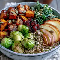 Roasted butternut squash and Brussels sprouts add warmth to this Fall Vegetable Bowl, topped with pumpkin seeds.